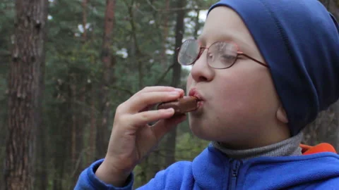 Boy eats chocolate in glasses Stock Footage 136852491