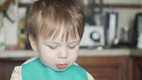 Boy eats cooked sausage 스톡 동영상 128450665