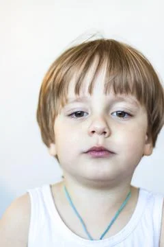 The boy eats a delicious berry and holds it in the palm of his hand. The plea Stock Photos