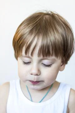The boy eats a delicious berry and holds it in the palm of his hand. The plea Stock Photos