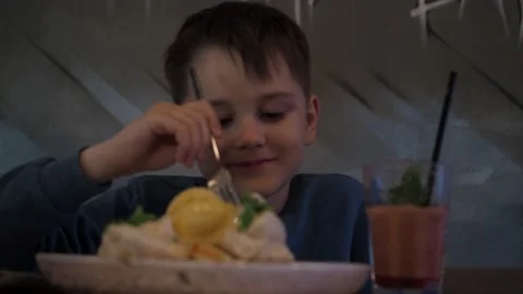 A boy eats dessert in a cafe. waffles with cream and smoothies in a glass. a Stock Footage 155296578