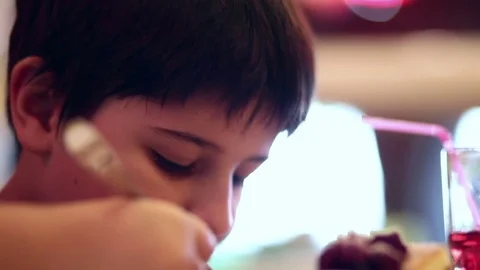 The boy eats a dessert spoon Stock Footage 75682493