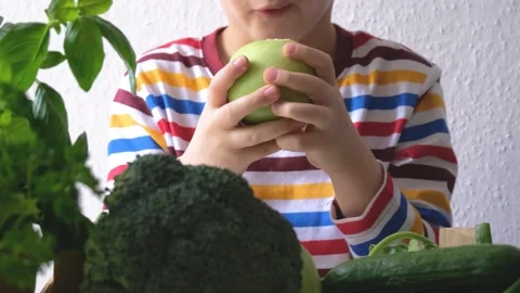 The boy eats a green apple. healthy food concept Stock Footage 223108545