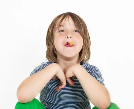 Boy eats gummy bears Photos