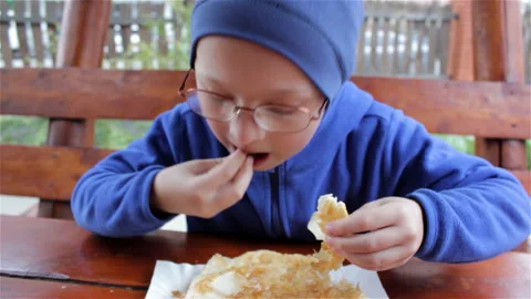 Boy eats hot chebureki Stock Footage 97649776