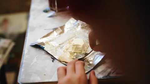 A boy eats ice cream from a package sitting at the kitchen table Stock Footage 321021744