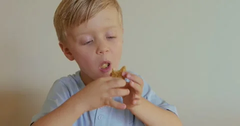 A boy eats nuggets at home Video stock 282666771