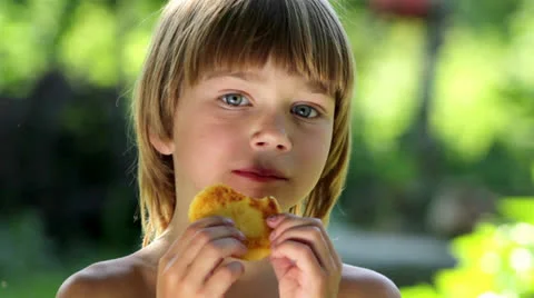 Boy eats pancakes Stock Footage 25357447