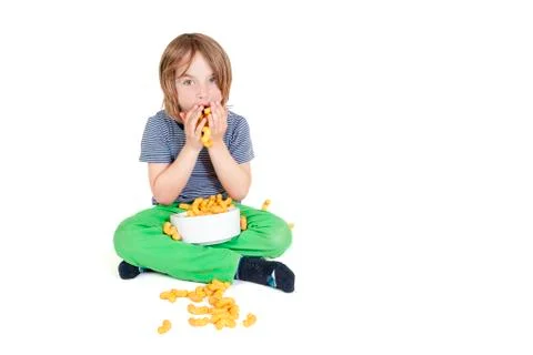 Boy eats peanut chips Stock Photos