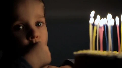 Boy eats a piece of cake on birthday Stock Footage 76761580
