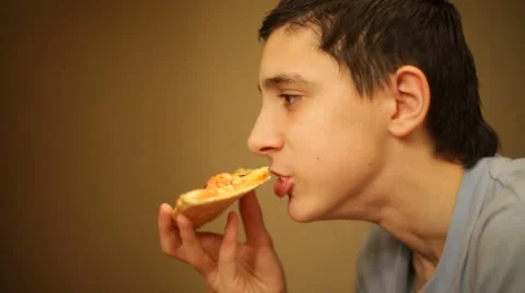 Boy eats a pizza 스톡 동영상 983083