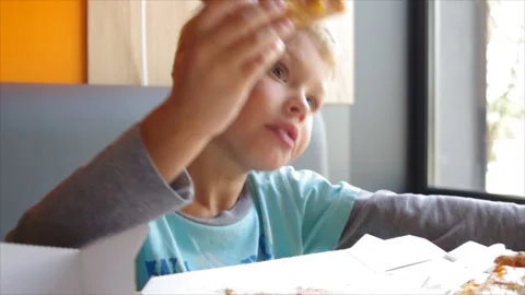 The boy eats up pizza Video stock 95586948