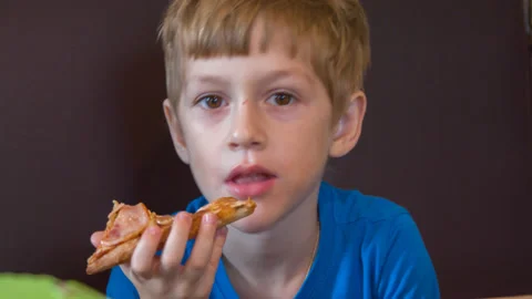 The boy eats pizza Stock Footage 142399550