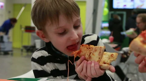 Boy eats pizza at the mall. Stock Footage 52461522