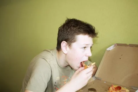 Boy eats pizza Stock Photos