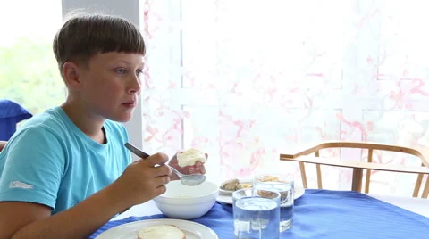 The boy eats porridge Stock Footage 52430769