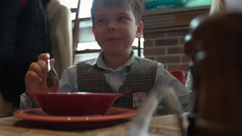 Boy eats soup in a cafe Stock Footage 72155725
