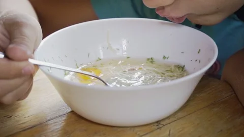 Boy eats a tasty and healthy soup in slow motion Stock Footage 126292251