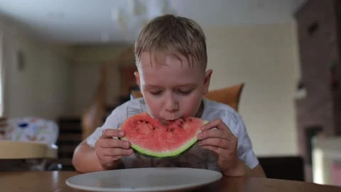 A boy eats a watermelon Stock Footage 130912743
