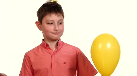 Boy eats yellow balloon with a needle and frightening explosion slow motion Stock Footage 48536875