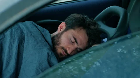 Boy in economic difficulty sleeping in the car Stock Footage 152762213