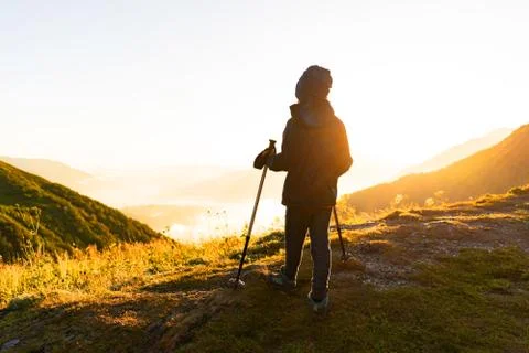 Boy on the edge of the mountain at sunset Stock Photos