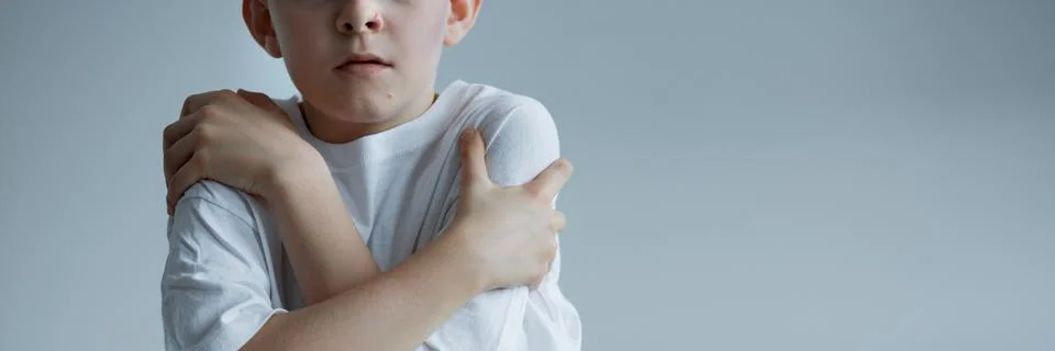 Boy embracing himself 库存照片
