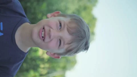 Boy emotionally chews an apple. vertical video Stock Footage 162482459