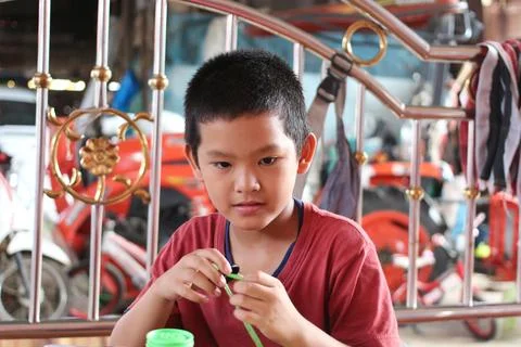 Boy Engaged in Creative Play with Green Toy Stock Photos
