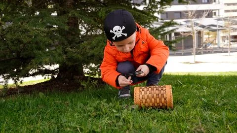 The boy is engaged in geocaching. Stock Photos