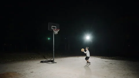 Boy enjoy basketball practice under the night sky Video stock 302824655