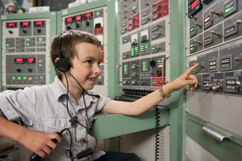 Boy enjoying interactive exhibit at space museum Stock Photos