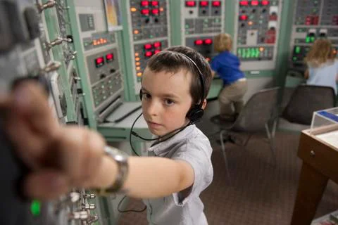 Boy enjoying interactive exhibit at space museum Stock Photos