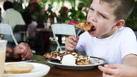 Boy enjoying plate of waffles. Stock Footage 277189029