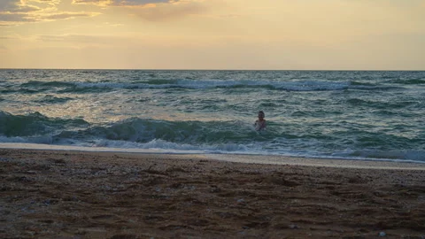 Boy Enjoying Sunset Beach Waves Stock Footage 312514748