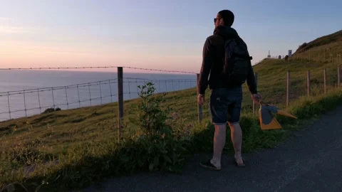 Boy enjoying the sunset from meadows Stock Footage 130854557