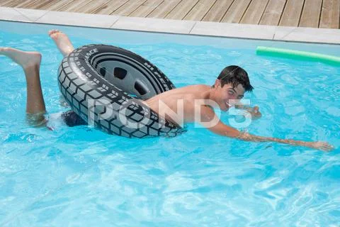 Boy is enjoying swimming pool on summer Stock Photos