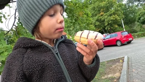 A Boy Enjoys a Donut During Snack Time Stock Footage 253485677