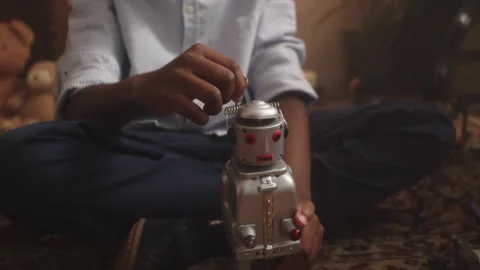 Boy enjoys imaginative playtime with toy robot in a cozy playroom Stock Footage 319911272