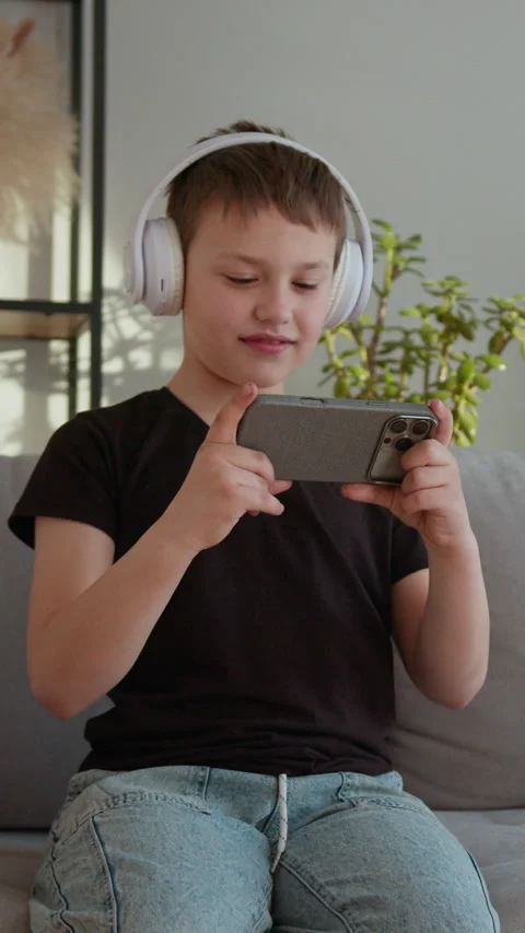 Boy Enjoys Mobile Game Stock Footage 335484711