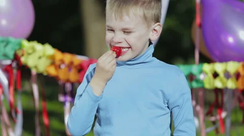 Boy enjoys strawberry. Stock Footage 49433455