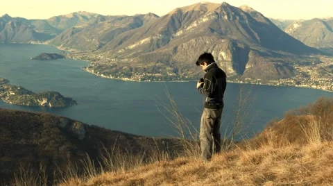 Boy examines the landscape with the telescope Stock Footage 59548704