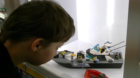 Boy examines a model ship in the shop window Stock Footage 62474754