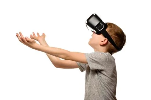 Boy experiencing virtual reality arms outstretched in front of him. Isolate o 스톡 사진