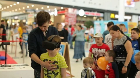 Boy experiencing VR headset with interest Stock Footage 84580997