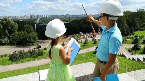 The boy explains the construction project to a little girl Stock Footage 97266128
