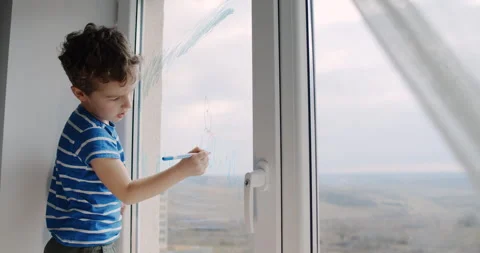 A boy explores the world beyond his window, showing curiosity Stock Footage 306673884