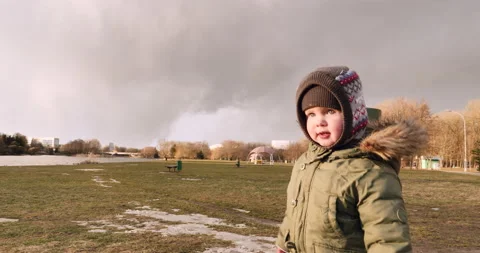 Boy Exploring Deserted Beach with Grey Skies, Solitary Lighthouse, Playgroun 動画素材 238766390