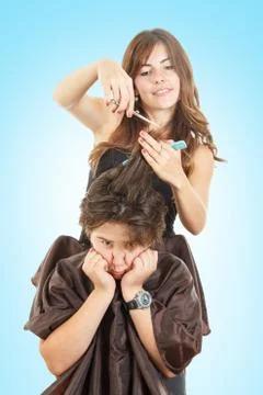 Boy with face expression with long hair at hairdresser Stock Photos