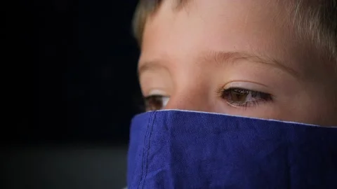 Boy in facemask is looking in the window from train. Boy in facemask watching Stock-Footage 138578319